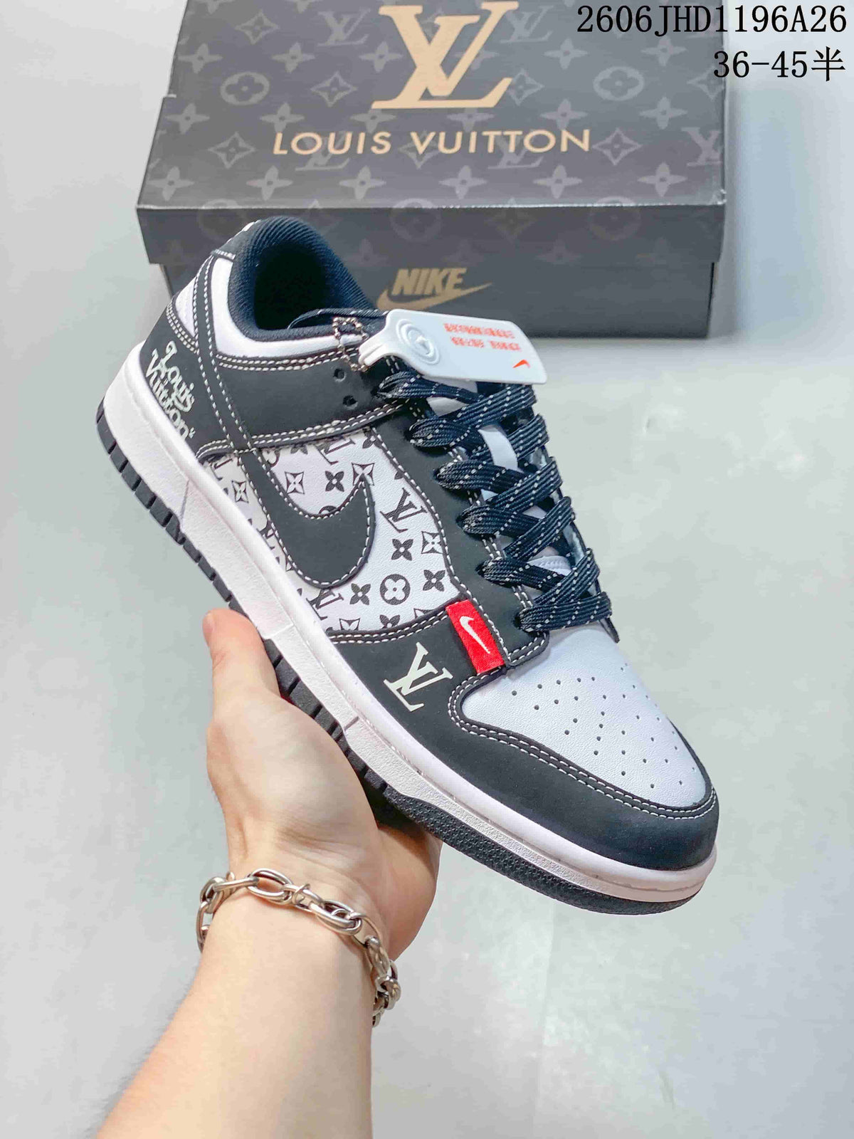 Close view of a dark gray and white patterned low-top sneaker with red accent tab and contrast stitching.