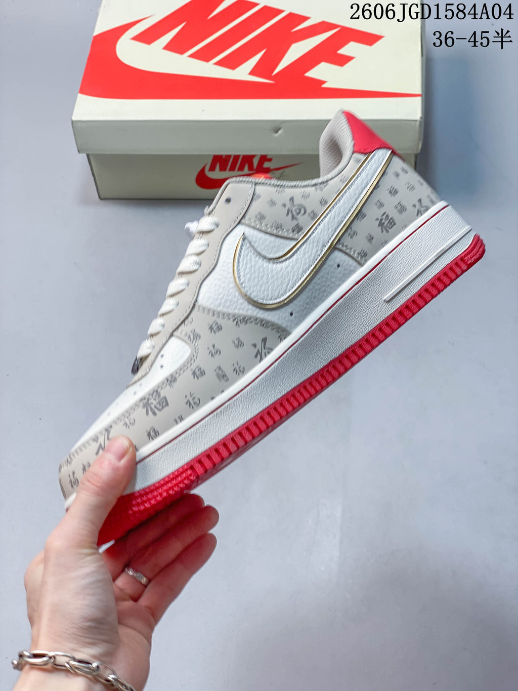 Side view highlighting the outlined Swoosh, printed panels, and red outsole
