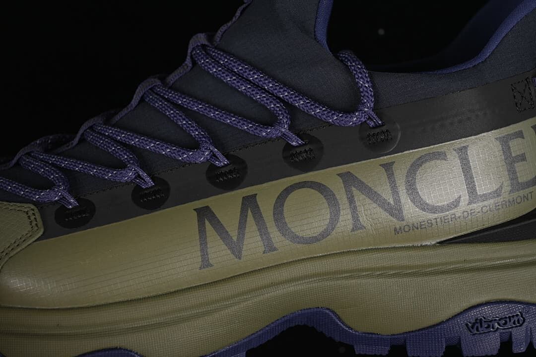 Close-up of side branding, lace loops, and lugged outsole