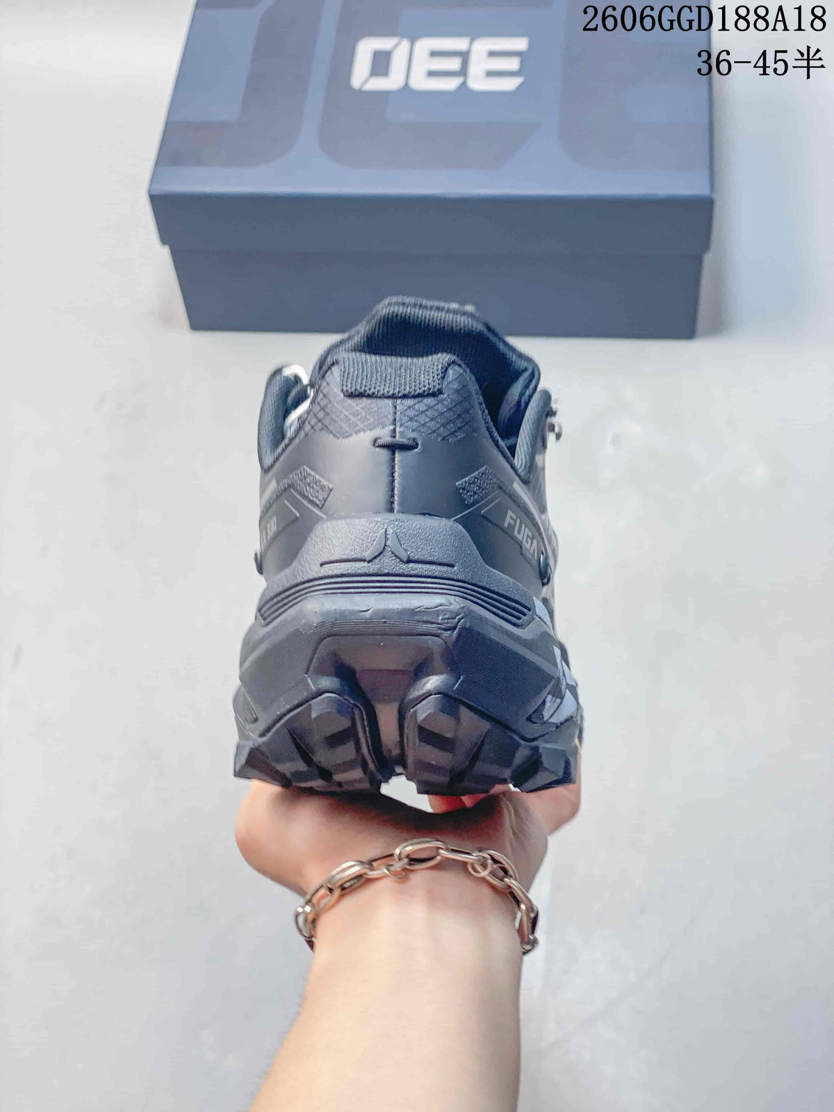 Rear view of the gray trail shoe showing the heel and lugged outsole