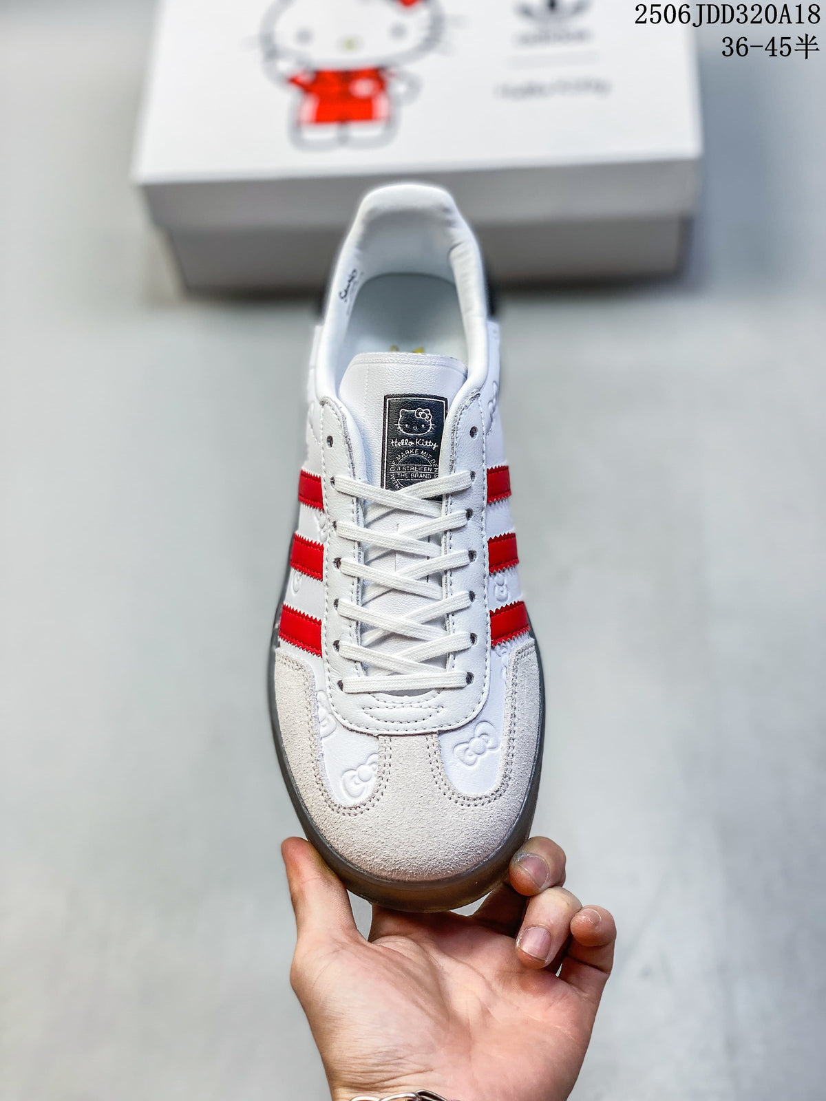 Front view showing the laces, red stripes, and character motifs