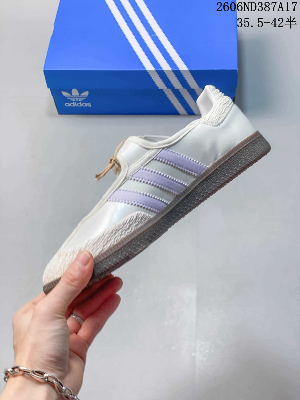 Side profile of the white sneaker with pale lavender stripes and a gum-tone outsole