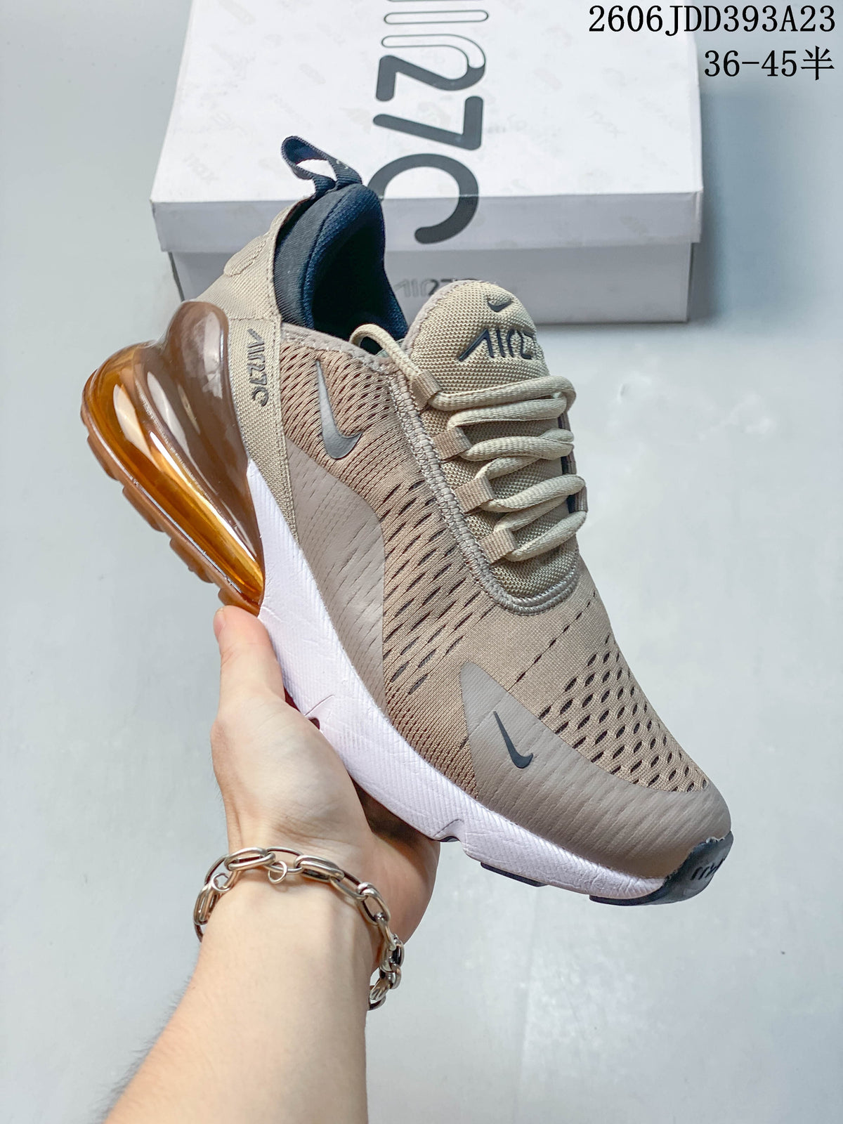 Angled side view of a beige and grey-toned Nike Air Max 270 sneaker.