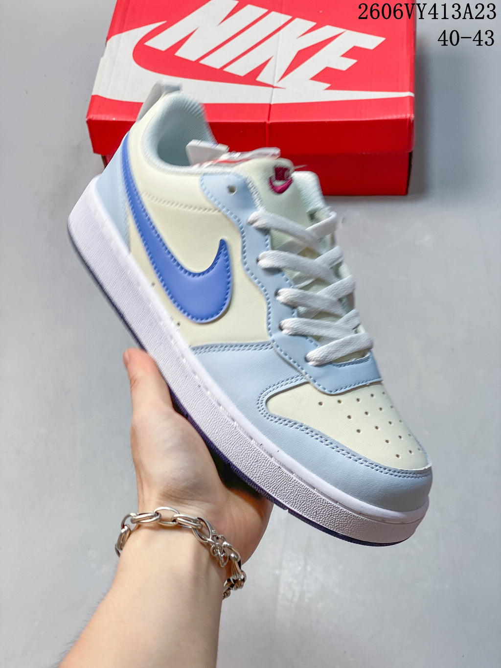 Angled side view of a light blue and white NikeCourt Borough 2 Low sneaker