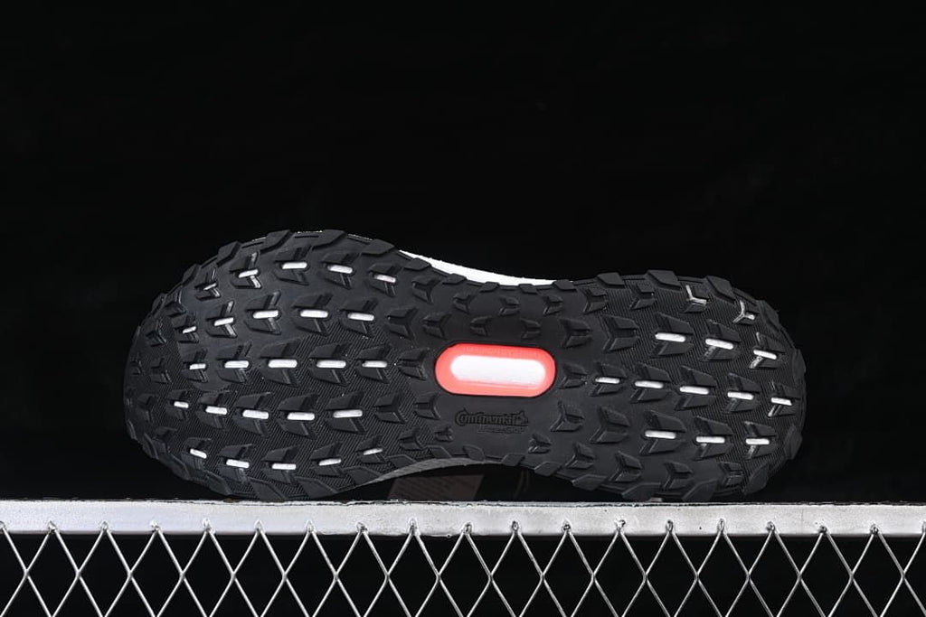 Underside view showing the black tread and red outsole accent.