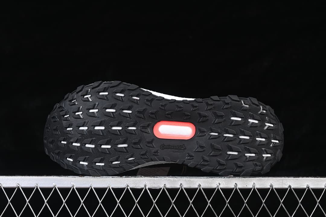 Underside view showing the black tread and red outsole accent.