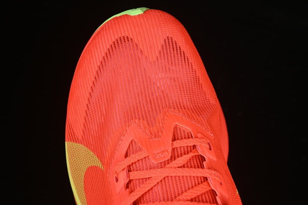 Front close-up of the mesh-like upper and lace construction.