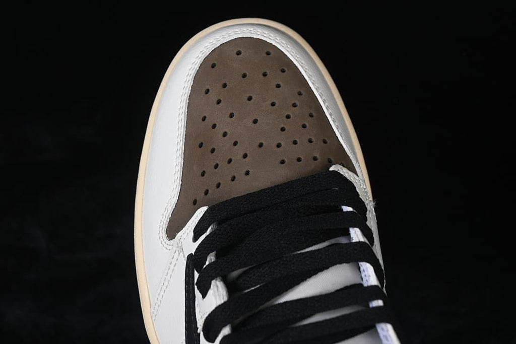 Top view of the perforated brown toe panel and black laces