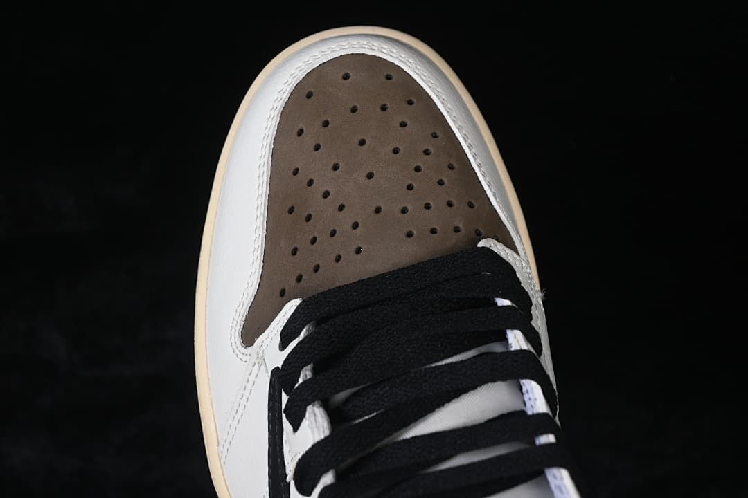 Top view of the perforated brown toe panel and black laces