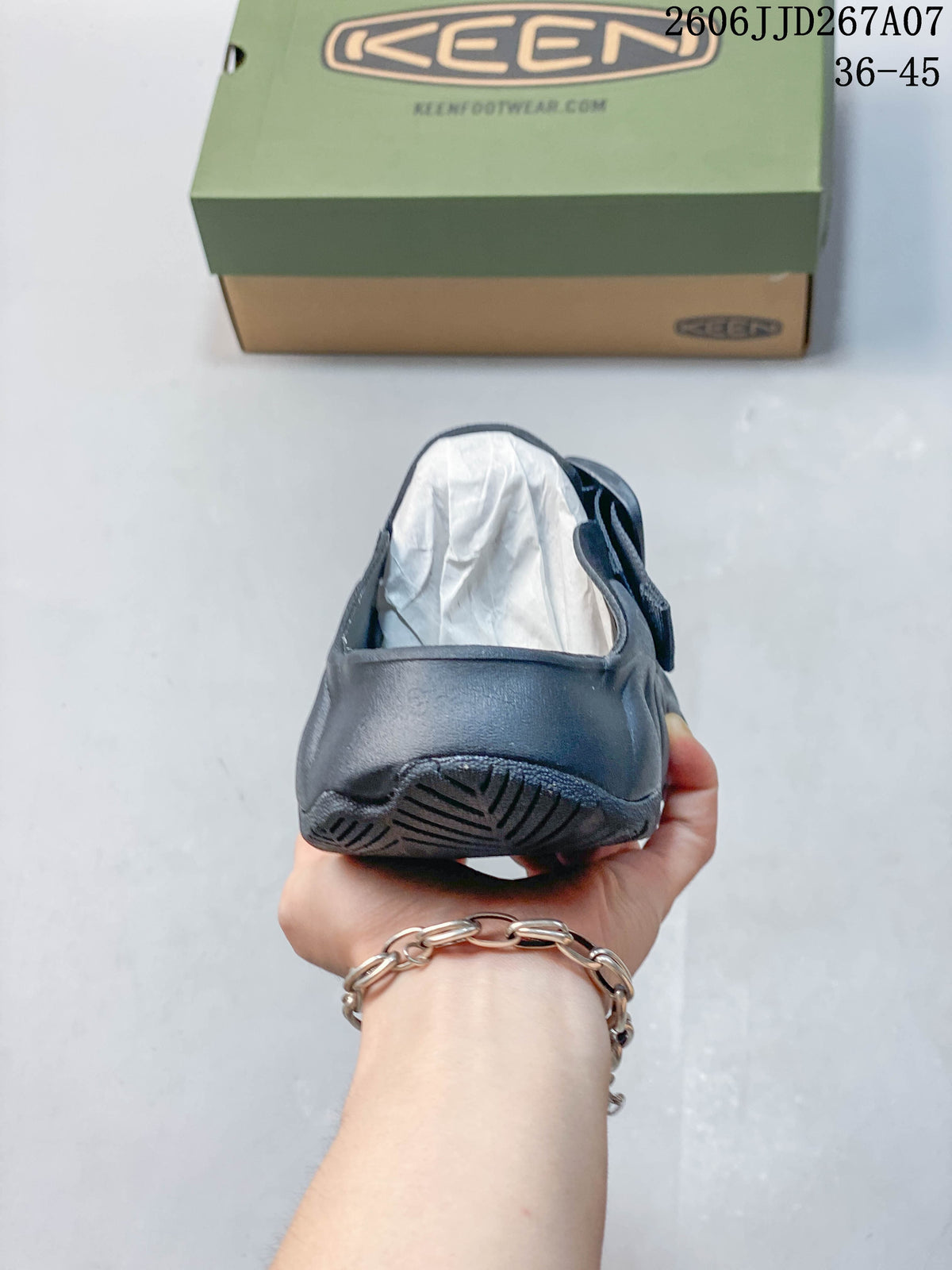 Rear view of the closed heel and outsole of the navy clog sandal.