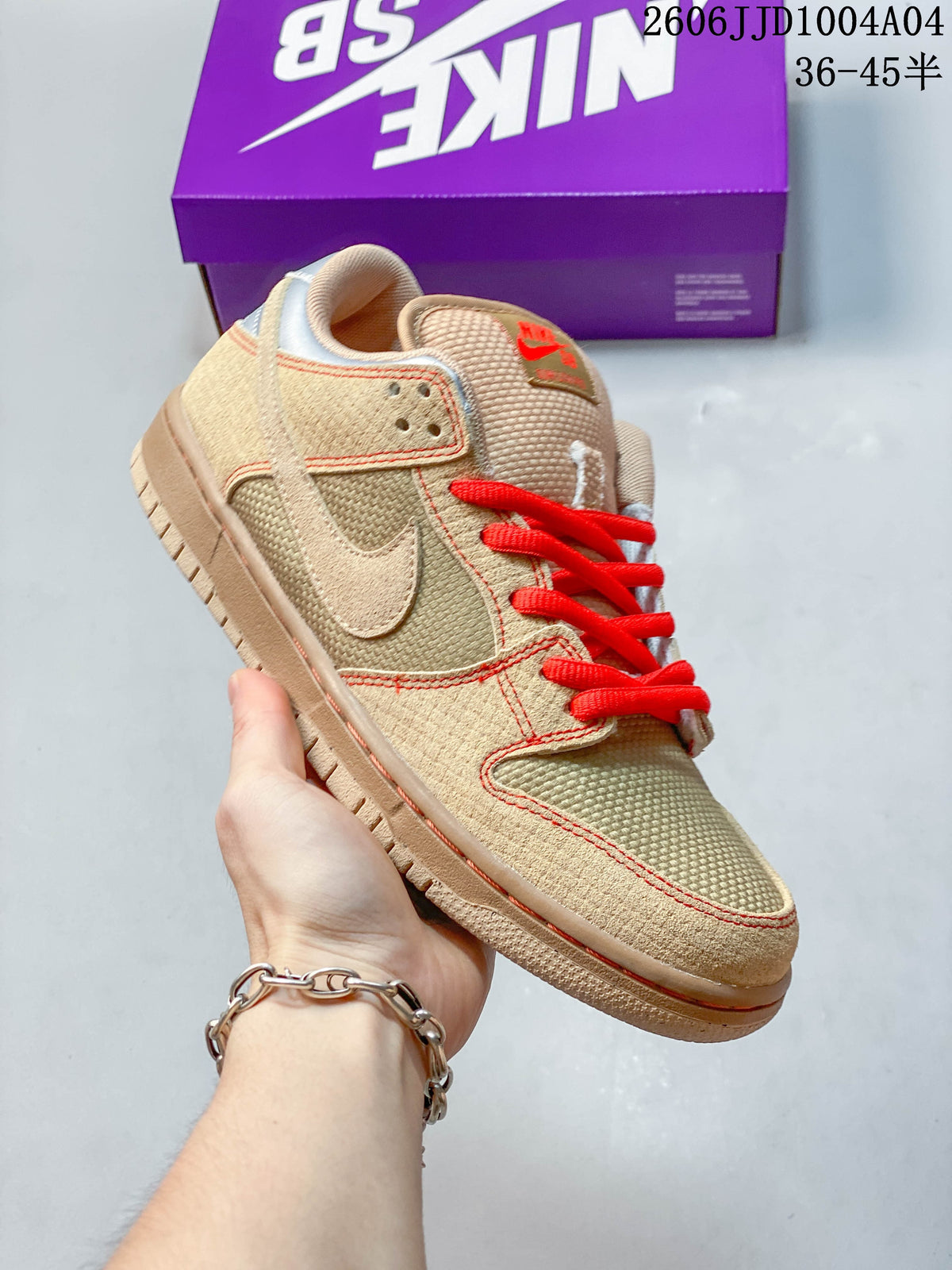 Angled view of the tan low-top shoe with red laces and silver accents