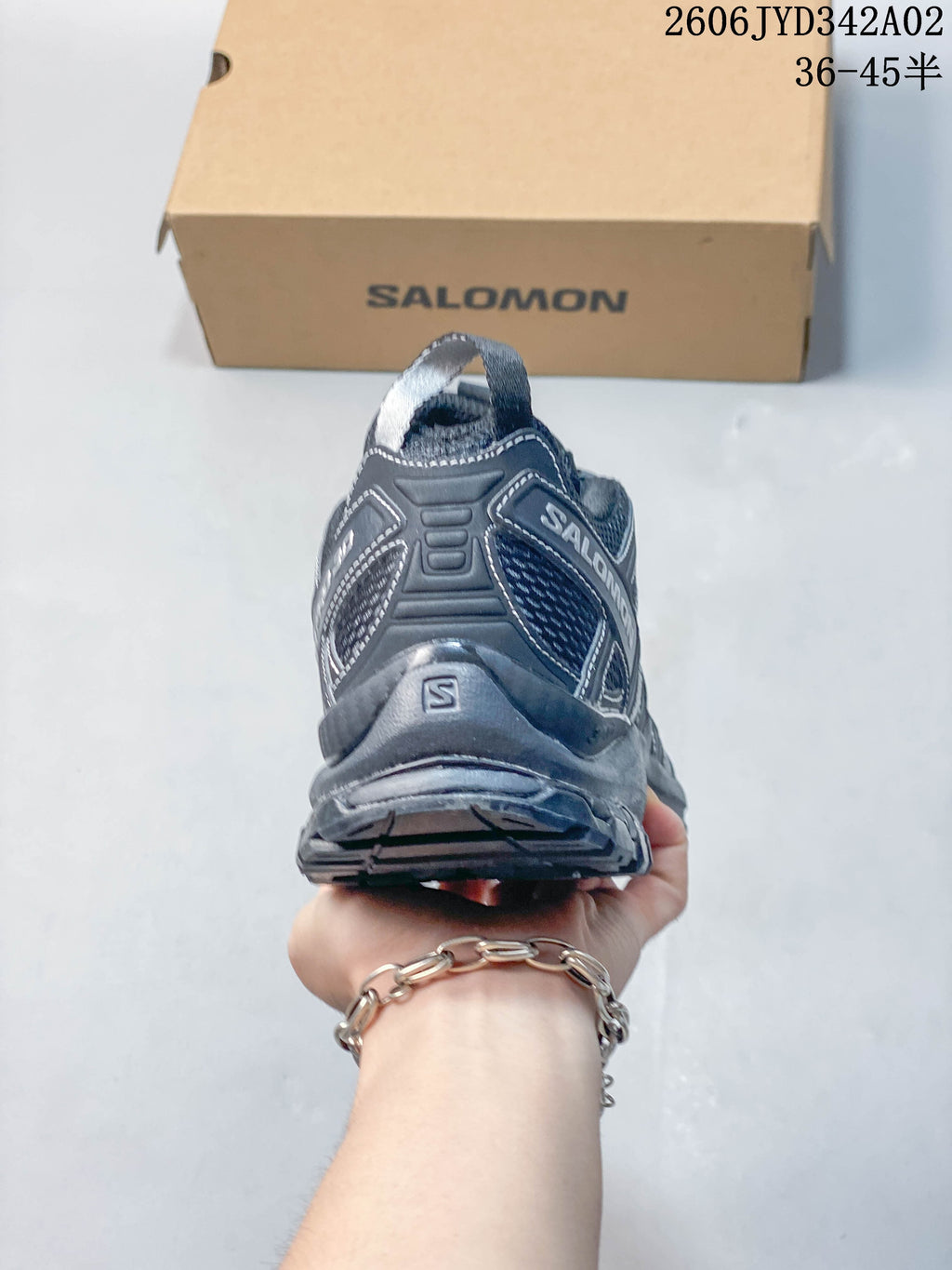 Rear view of a dark gray Salomon trail running shoe