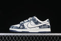 Side view of white and blue Nike SB Dunk Low sneakers with denim-style patterned panels