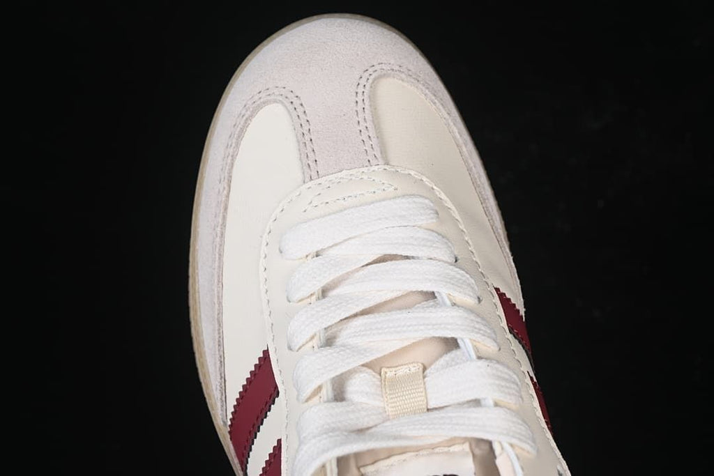 Top-down close-up of the toe, suede-look overlays, and white laces.