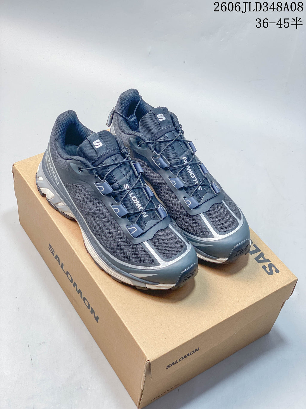 Blue-gray Salomon XT-6 FT sneakers displayed on a branded shoe box