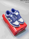 Pair of purple and white Nike SB Dunk Low Pro sneakers shown on a red shoe box.