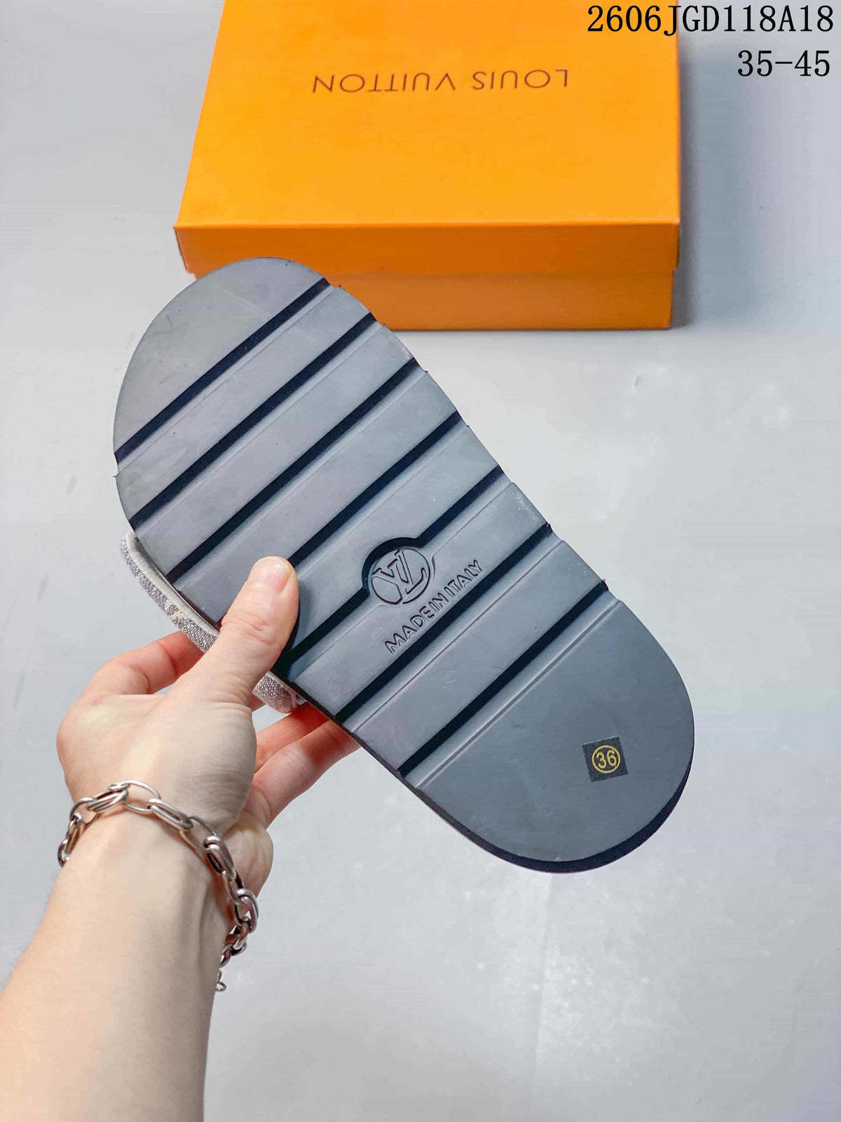 Underside of a slide sandal showing a ridged outsole and EU size 36 mark