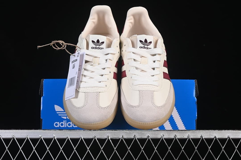 Front view of the pair displayed on a blue adidas shoe box.