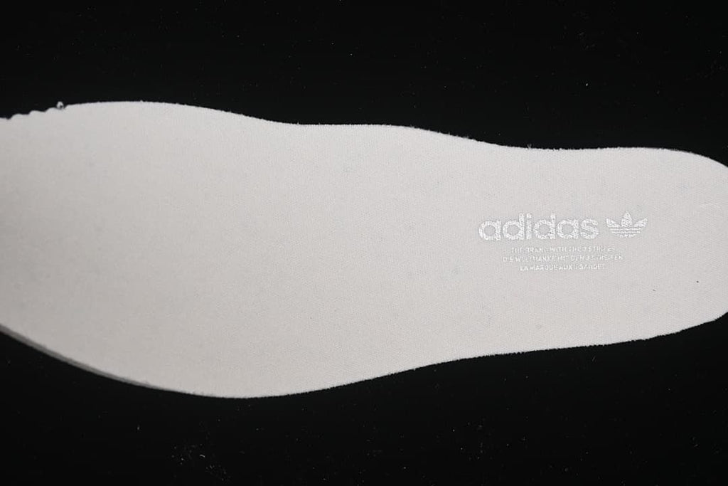 Light-colored insole with adidas branding.