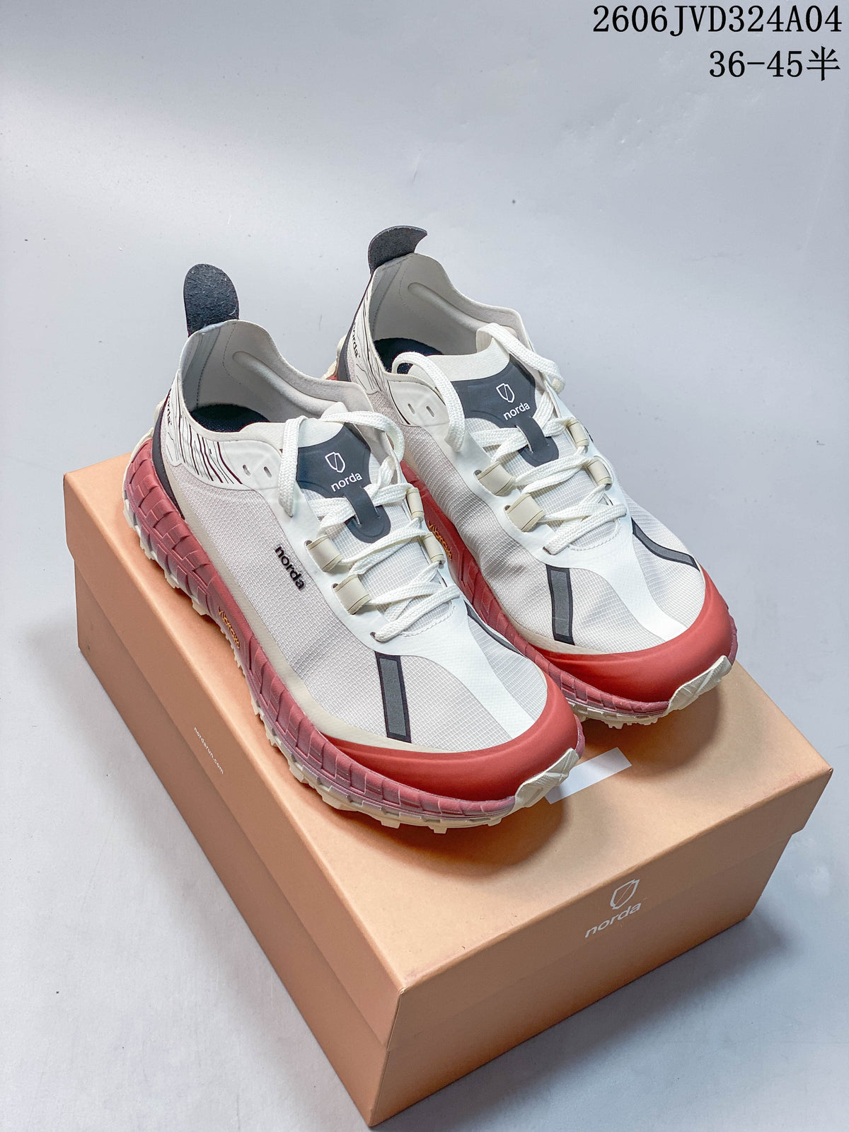 Pair of white Norda 001 sneakers with dark accents and rose-colored soles, shown on a box.