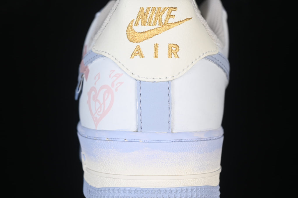 Rear close-up showing gold Nike Air heel branding and pink graphics