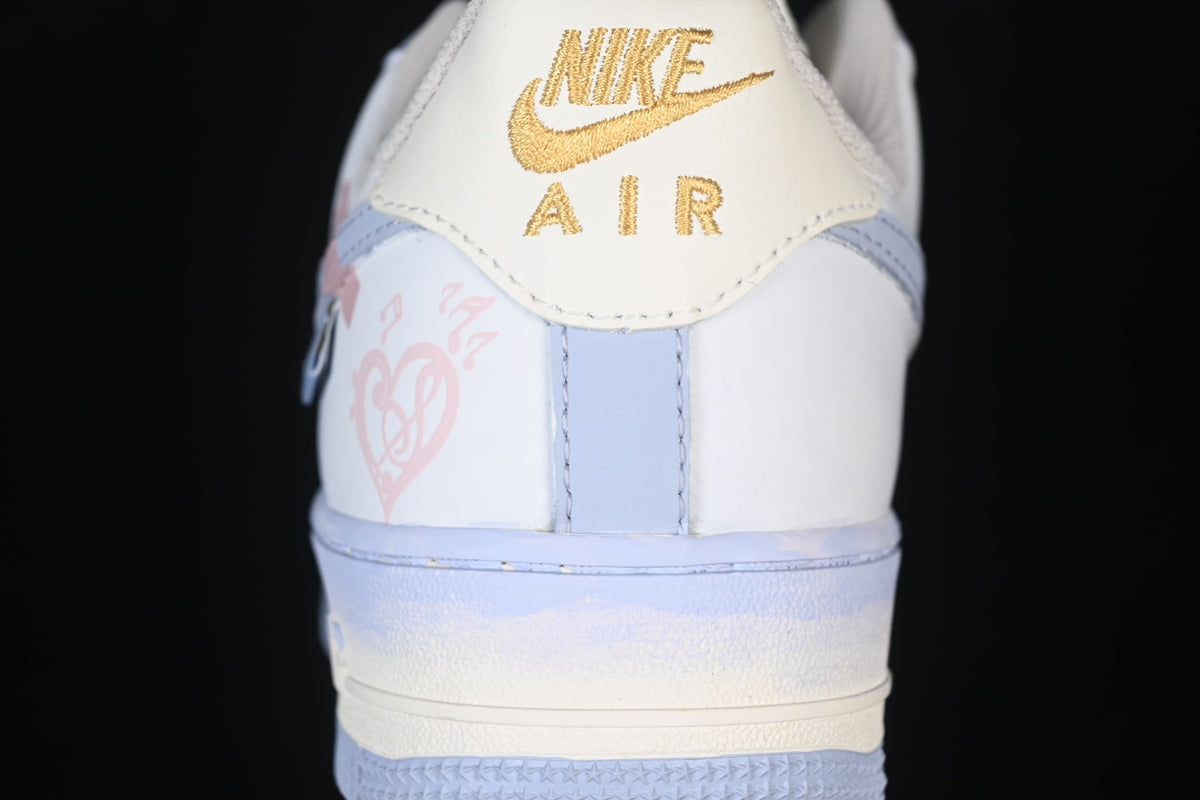 Rear close-up showing gold Nike Air heel branding and pink graphics