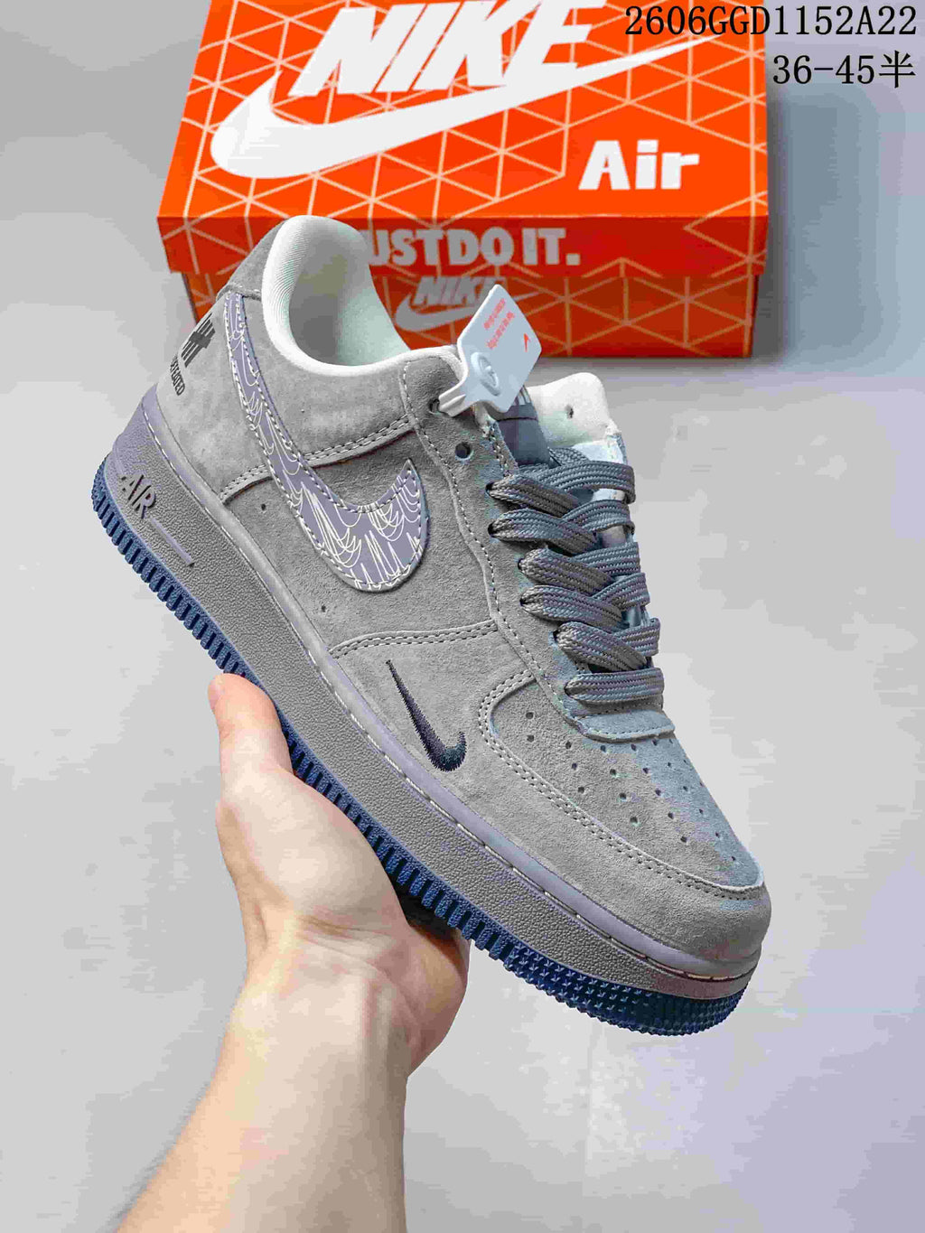 Close-up of a gray low-top sneaker with patterned side accent and textured outsole.