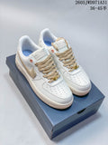 Pair of white low-top Nike Air Force 1 ’07 sneakers with beige laces and side detailing, displayed on a shoe box.