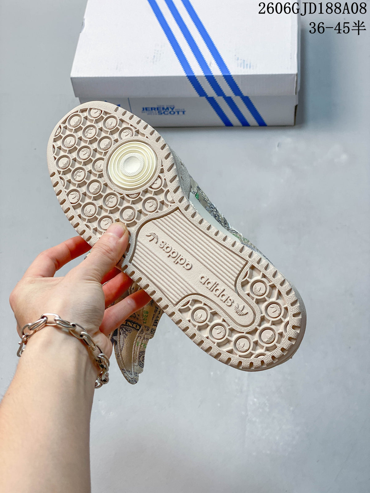 Close-up of the sneaker outsole with circular tread pattern and adidas branding