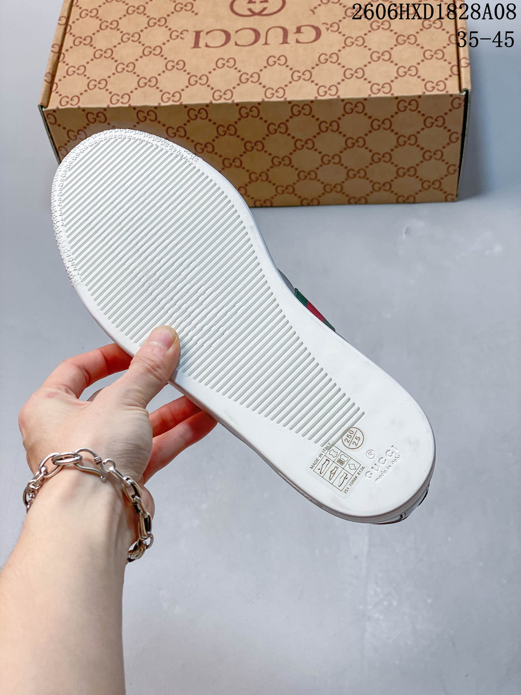 Underside of a white sneaker sole with a ridged tread; printed markings include 250 and 2.5.