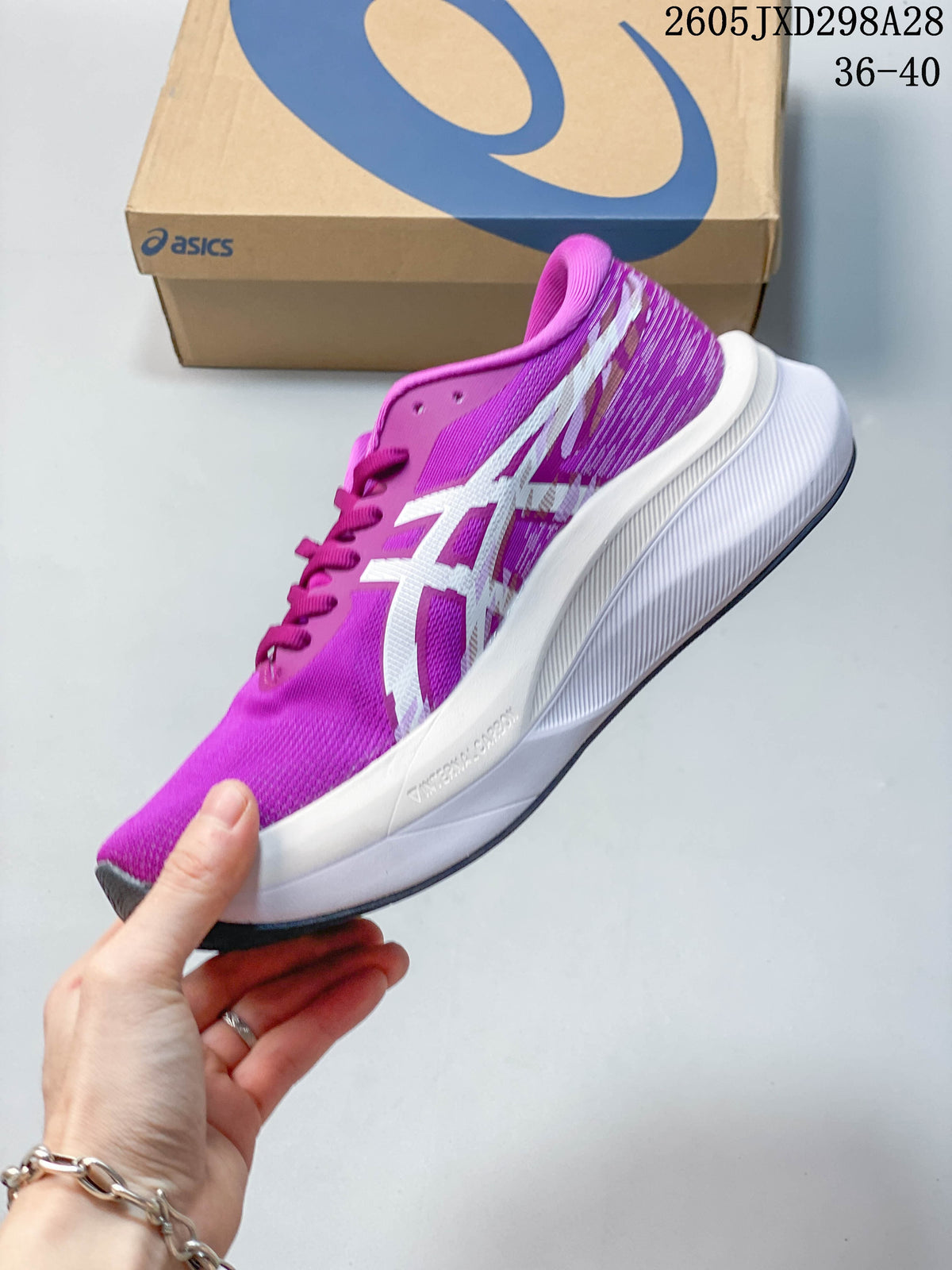 Side view of the purple ASICS running shoe with white stripes and a white midsole