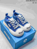 Blue Ocai 002 Smile low-top sneakers with white laces and oversized white toe bumpers on a blue box.