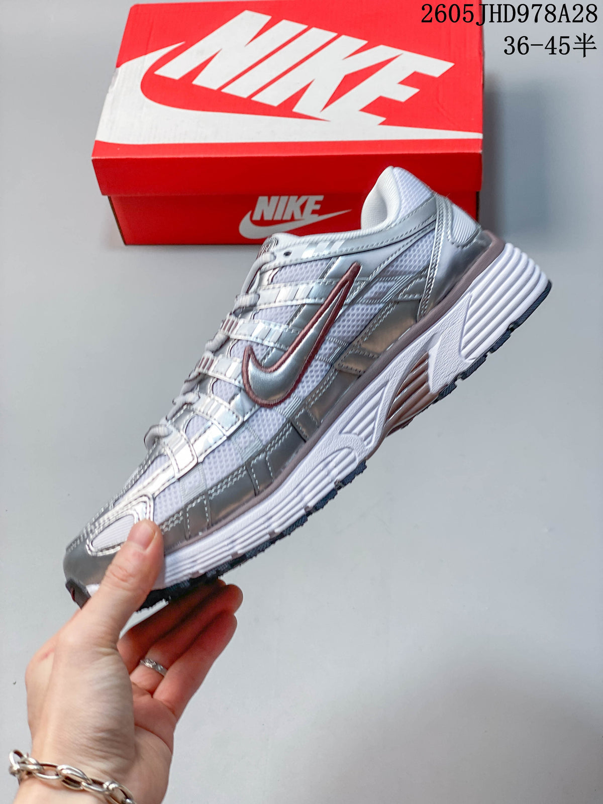 Side profile of the silver and white Nike Initiator shoe