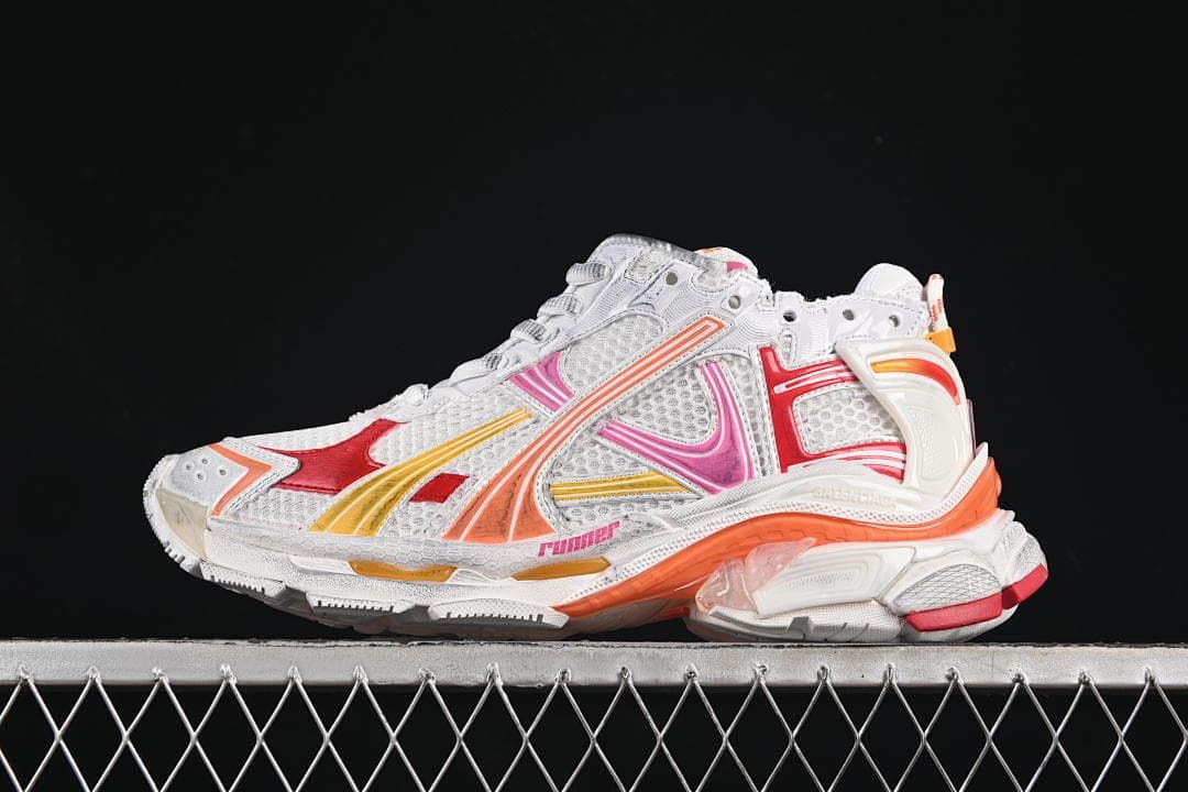 Side view of white Balenciaga Runner sneakers with red, pink, orange, and yellow accents