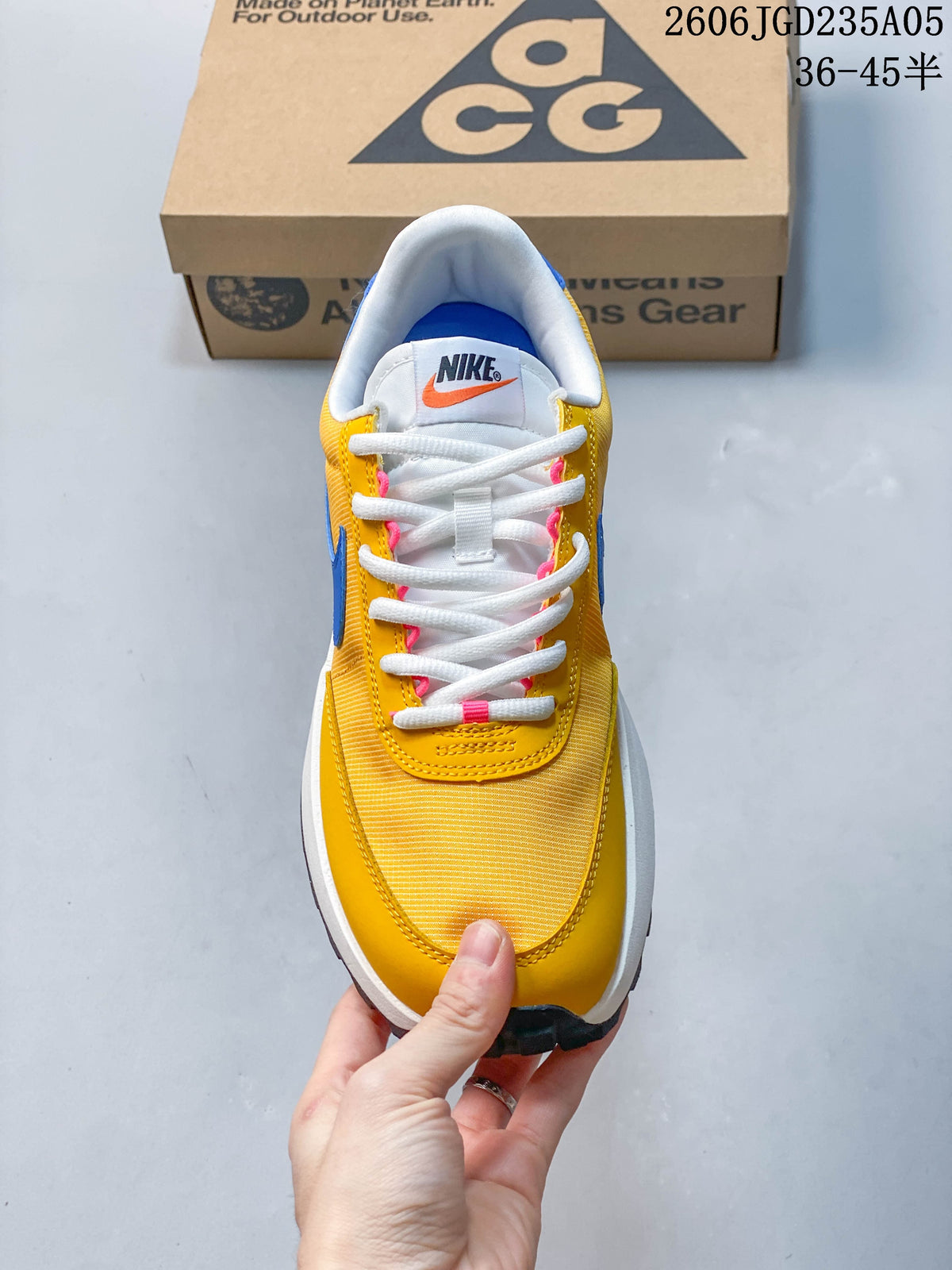 Top view of the shoe showing white laces and yellow upper with pink details