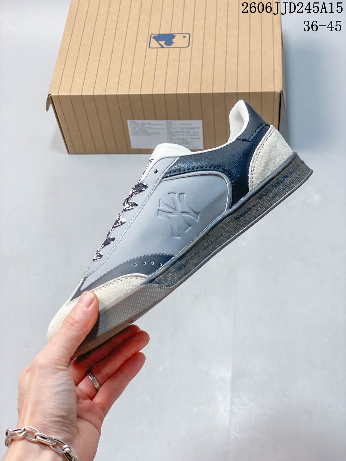 Side view of a low-top sneaker with team graphics and mixed-look panels