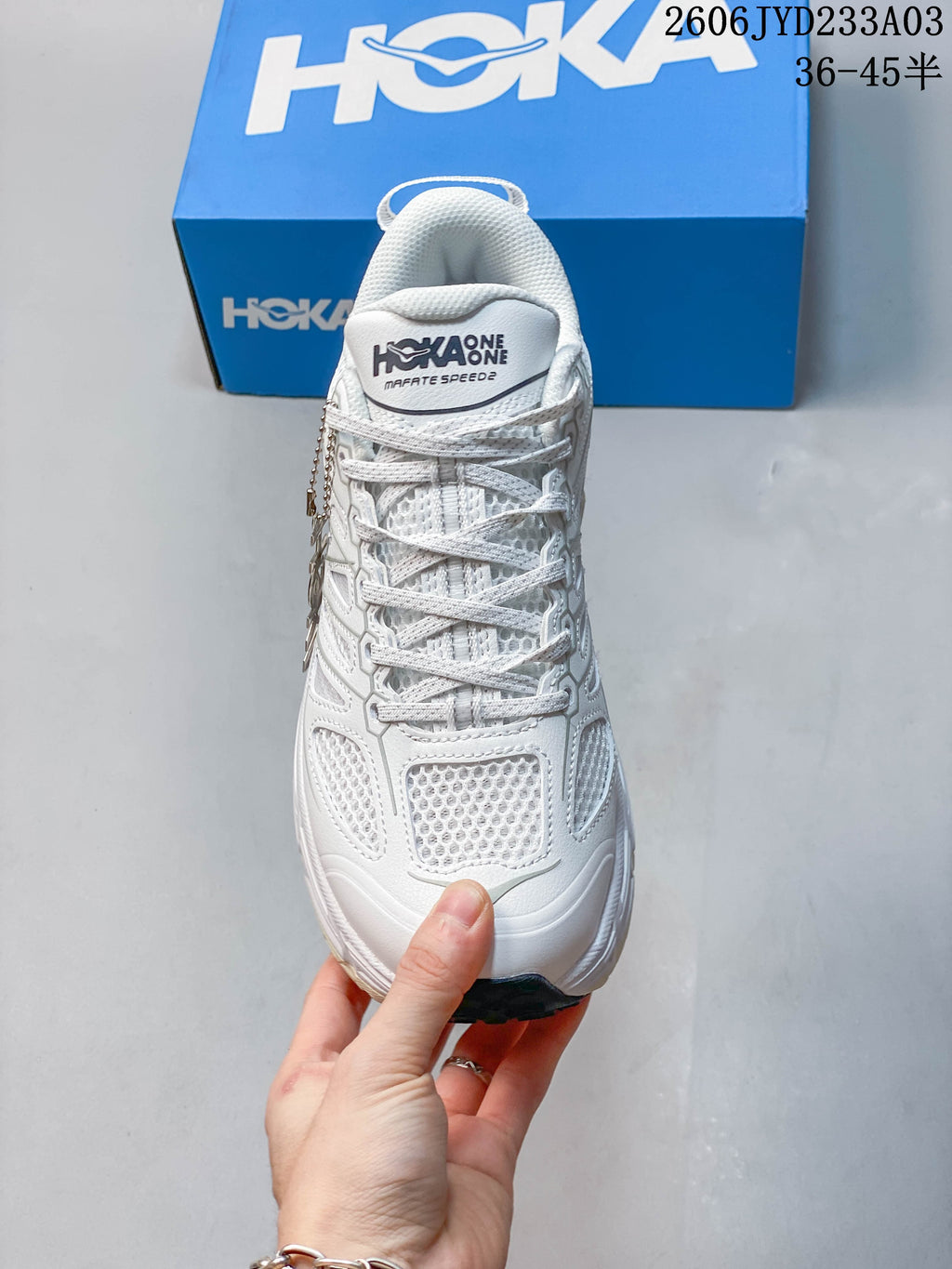 Front view of a white HOKA Mafate Speed trail shoe with laces