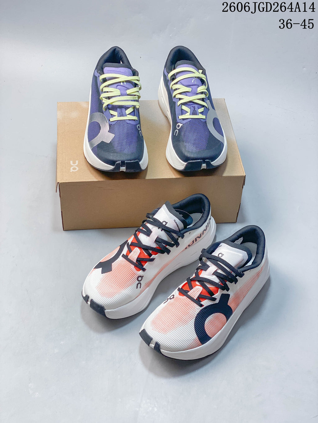 Two pairs of On Cloudboom Volt running shoes shown in navy and purple with lime laces and white and coral with dark laces.