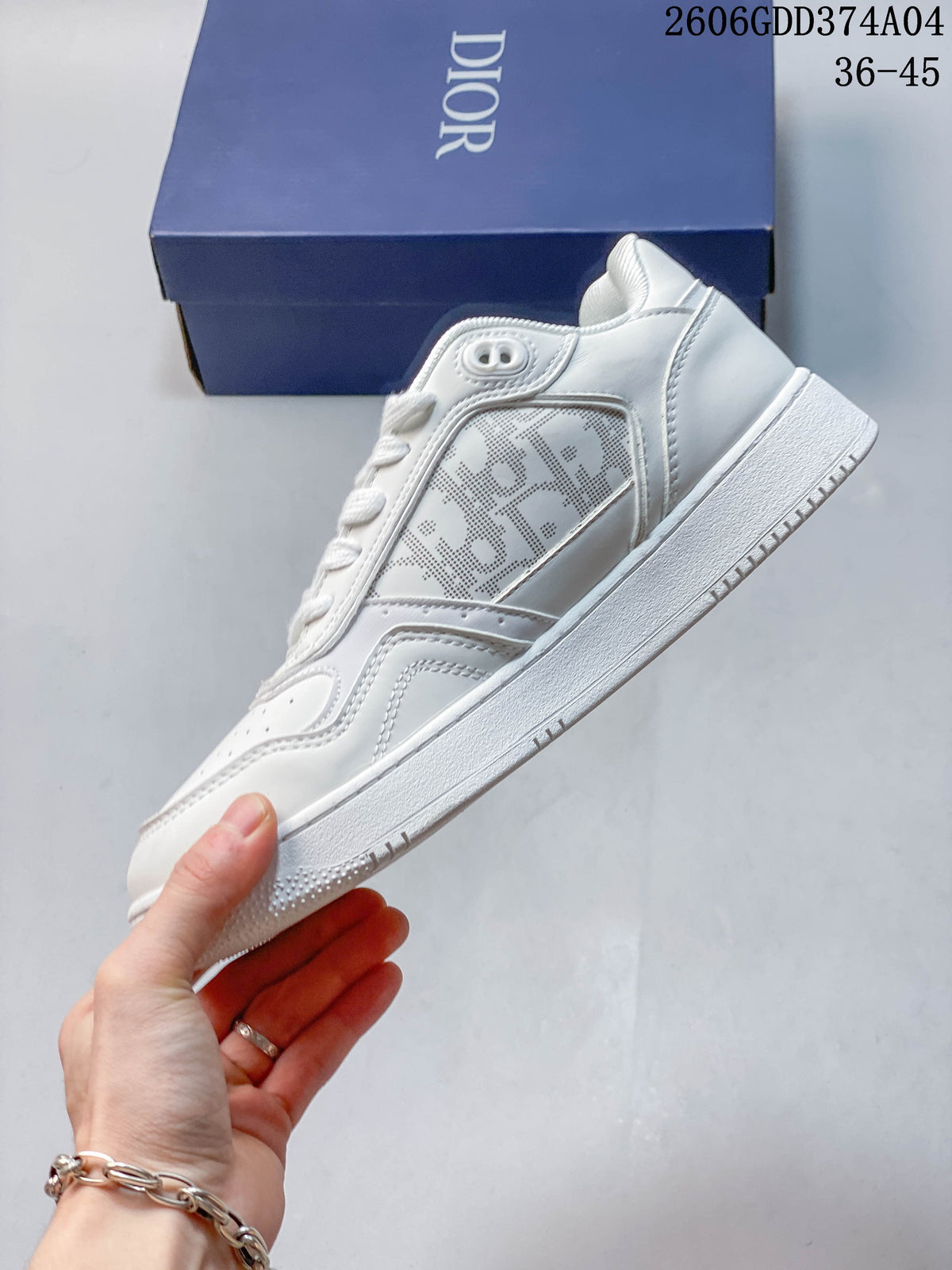 Side view of a white low-top sneaker with a patterned panel and textured outsole.