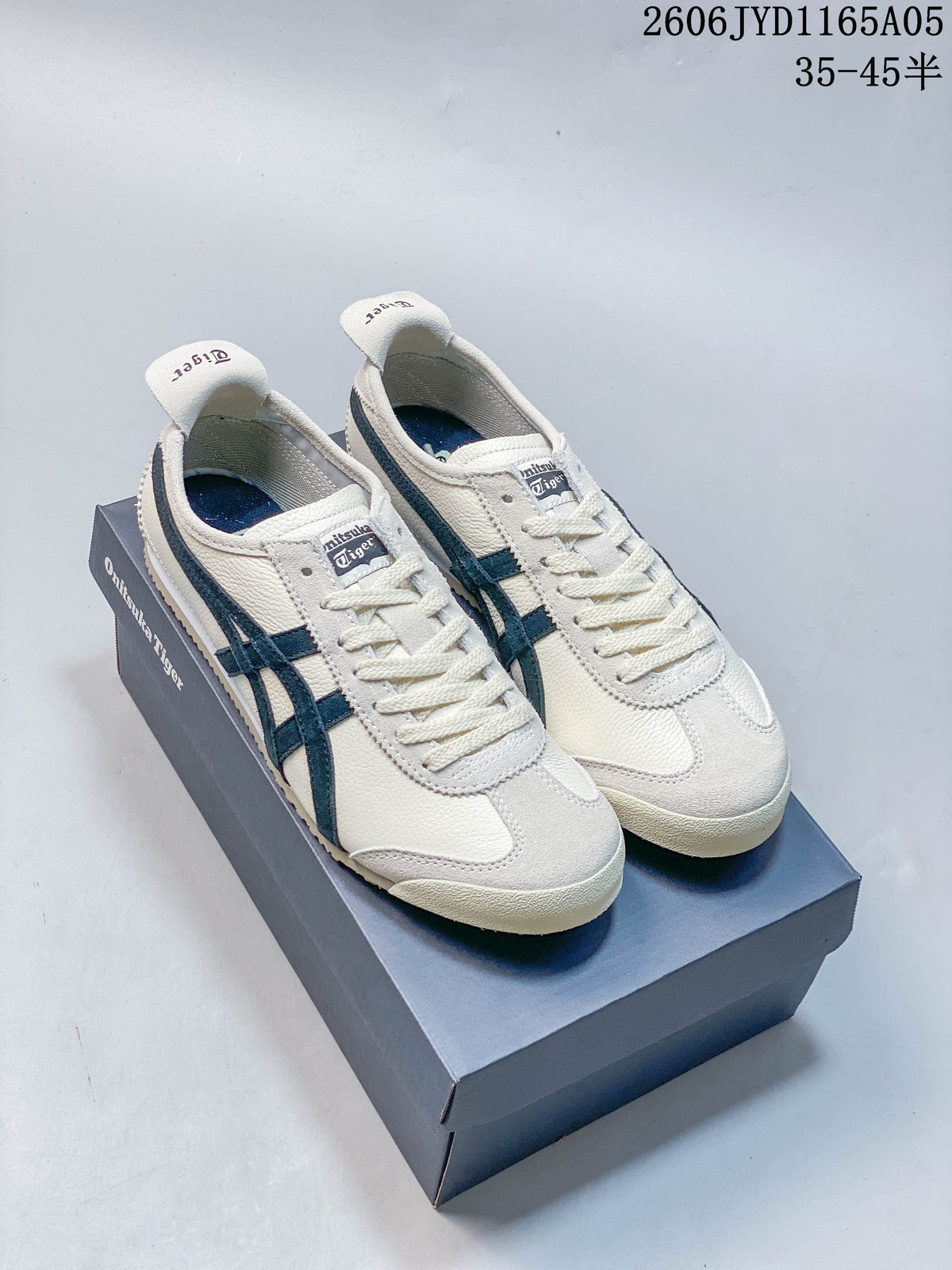 Pair of ivory-colored Onitsuka Tiger Mexico 66 sneakers with dark navy stripes, shown on a shoe box.