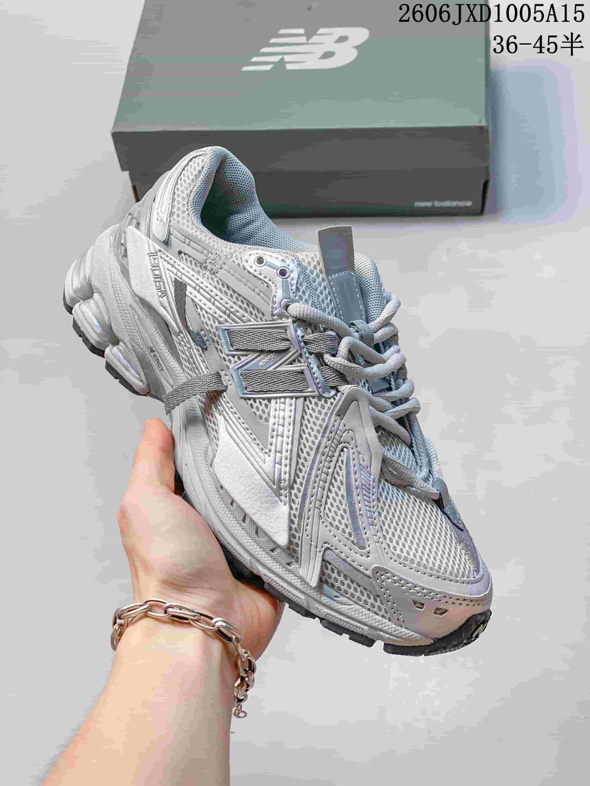 Angled side view of a silver-grey New Balance 1906 sneaker