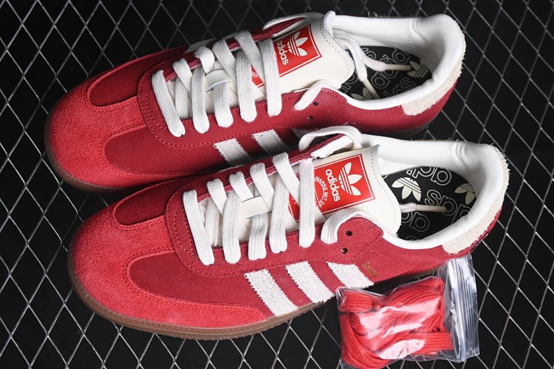 Pair of red Samba OG Tal sneakers with an extra set of red laces pictured beside them.