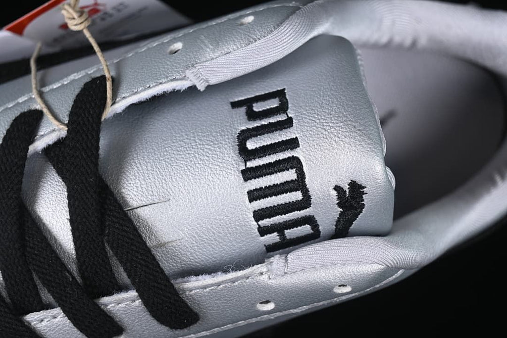 Close-up of the Puma-branded tongue and black laces.