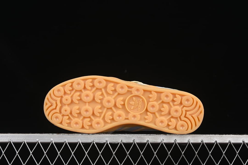 Underside view showing the patterned gum-colored outsoles