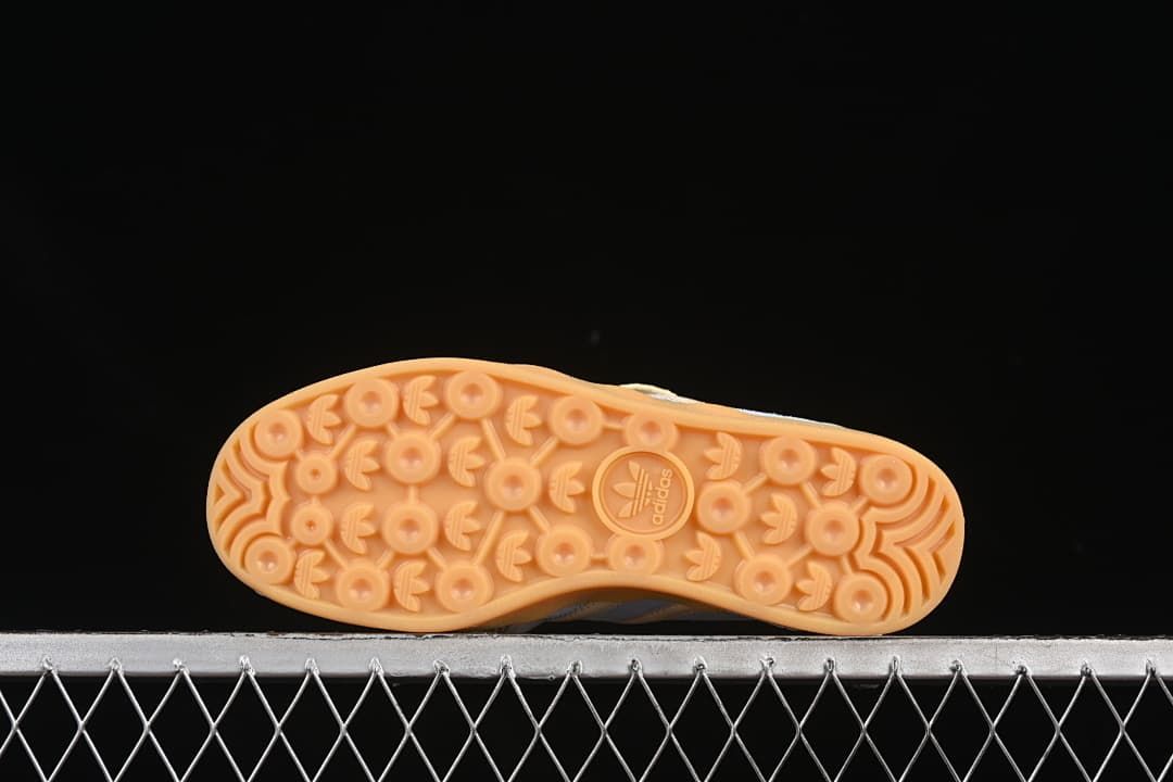 Underside view showing the patterned gum-colored outsoles
