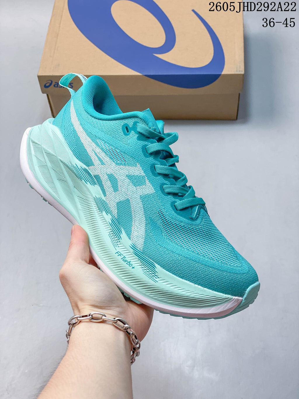 Turquoise ASICS Superblast 2 Paris running shoe with pale aqua midsole accents.