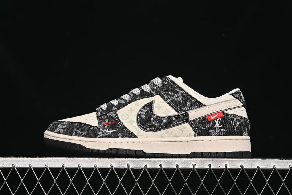 Side view of a cream and black low-top sneaker with monogram-style panels and a dark Swoosh-shaped detail.