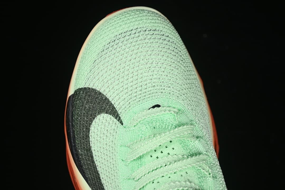 Top-down close-up of the mint-green toe and black Swoosh