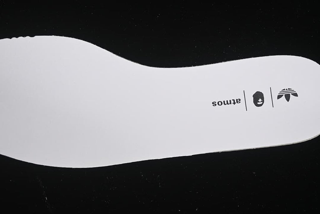 Insole printed with adidas, BAPE, and atmos branding