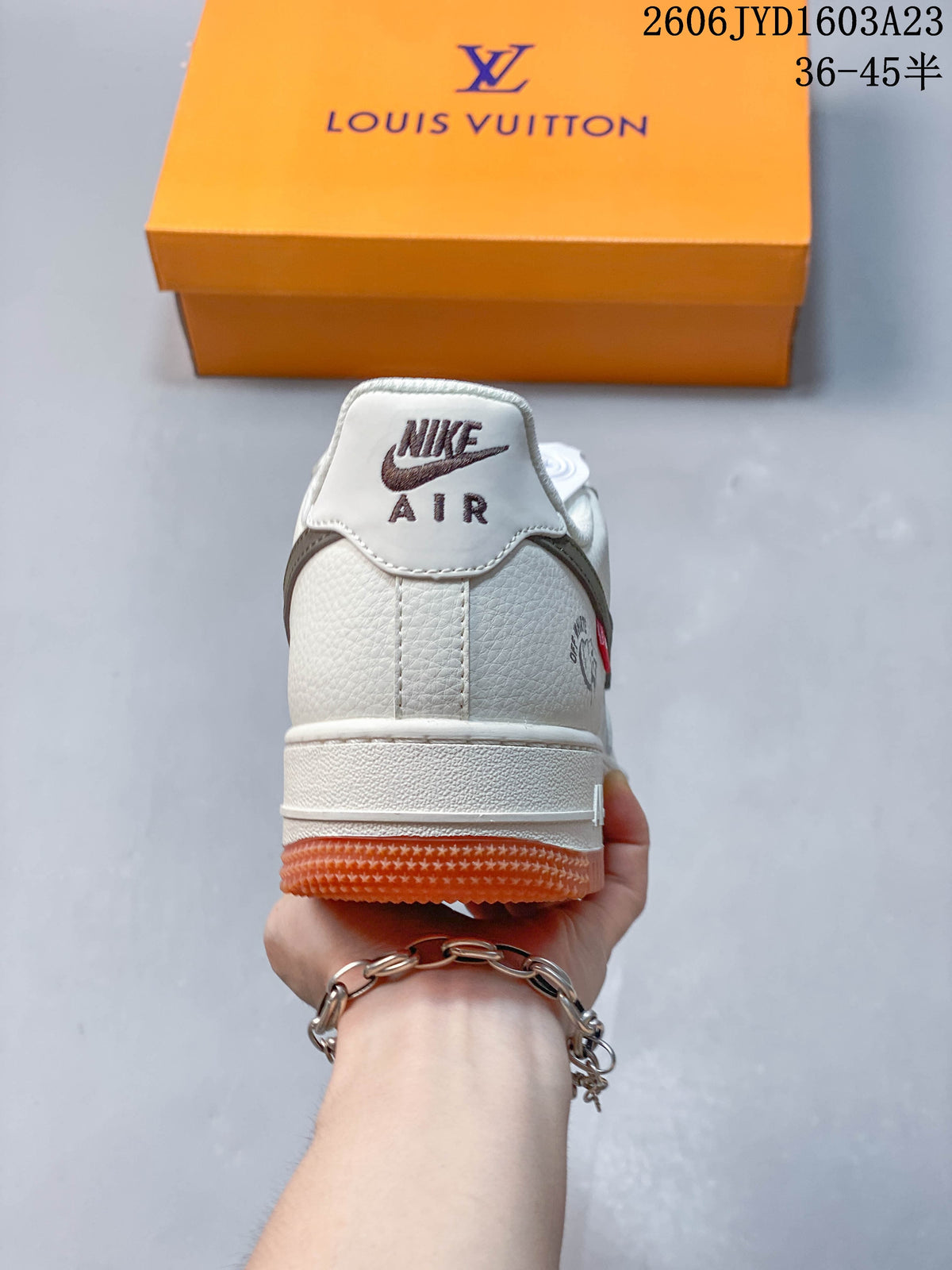 Rear view showing the off-white heel, gray details, and orange outsole